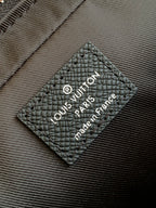 Louis Vuitton bag, black leather care label with Louis Vuitton Paris text