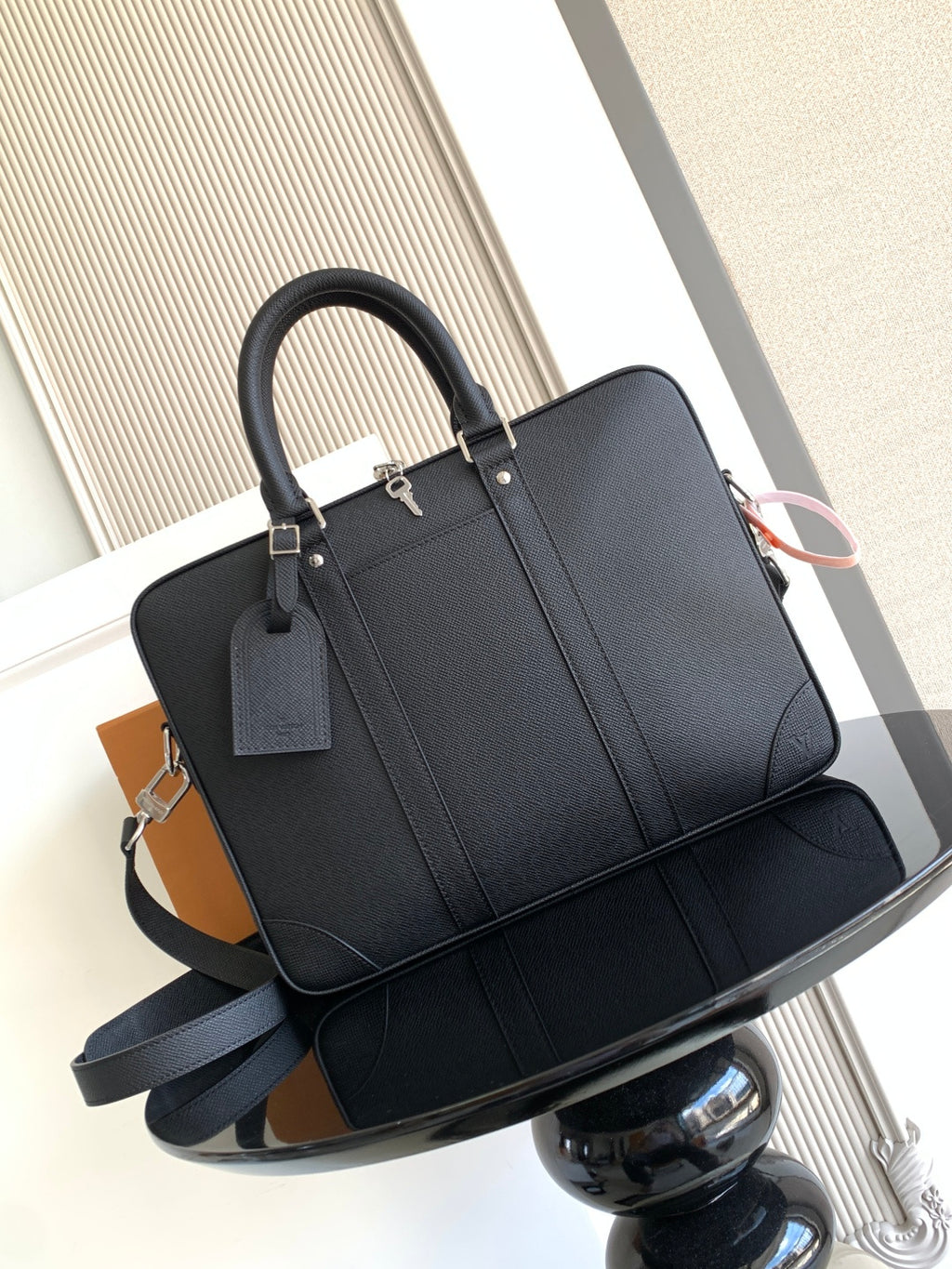 Louis Vuitton bag, dark structured tote with top handles and long shoulder strap