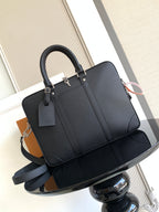 Louis Vuitton bag, dark structured tote with top handles and long shoulder strap