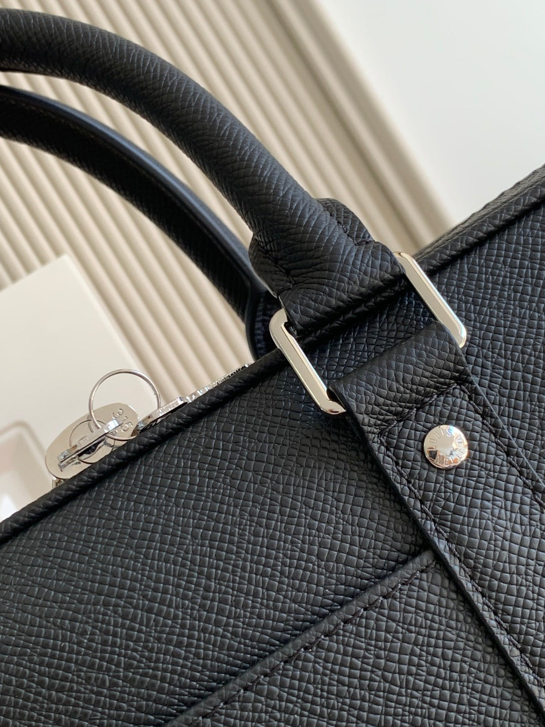 Louis Vuitton bag, dark pebble-grain leather top handle with metal ring attachment
