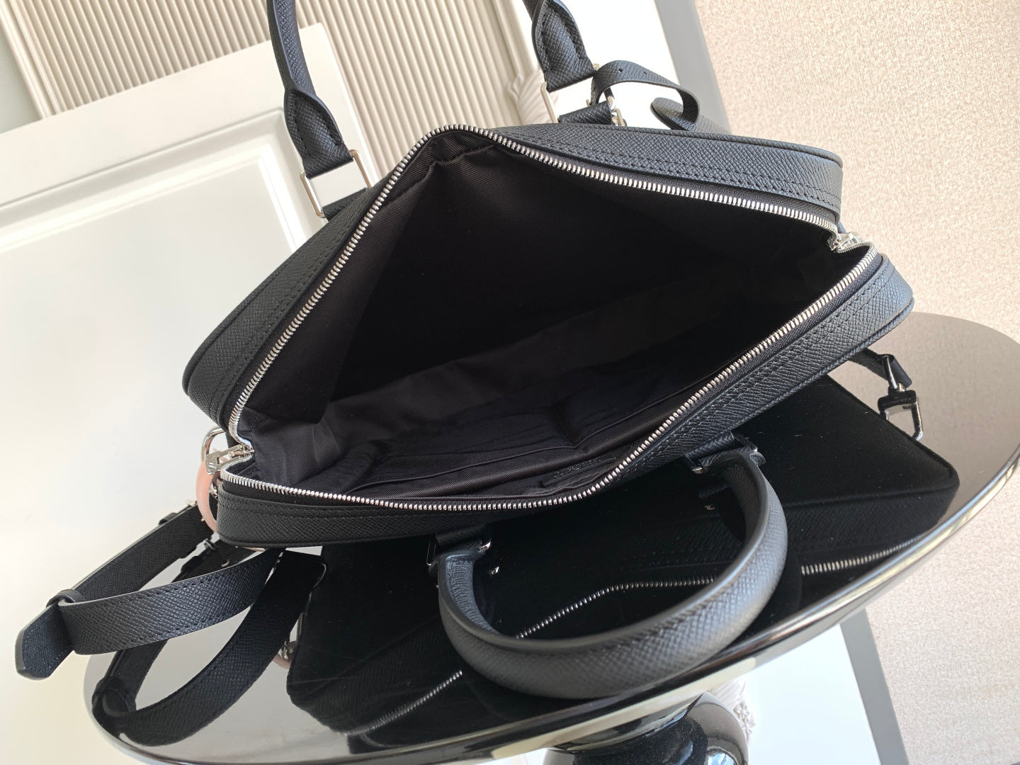 Louis Vuitton bag, dark zip-top tote with open interior and shoulder strap