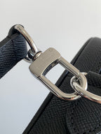 Louis Vuitton bag, dark leather strap attachment with polished D-ring and logo plate