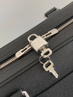 Louis Vuitton bag, dark leather zipper with metal pulls and key-ring hardware