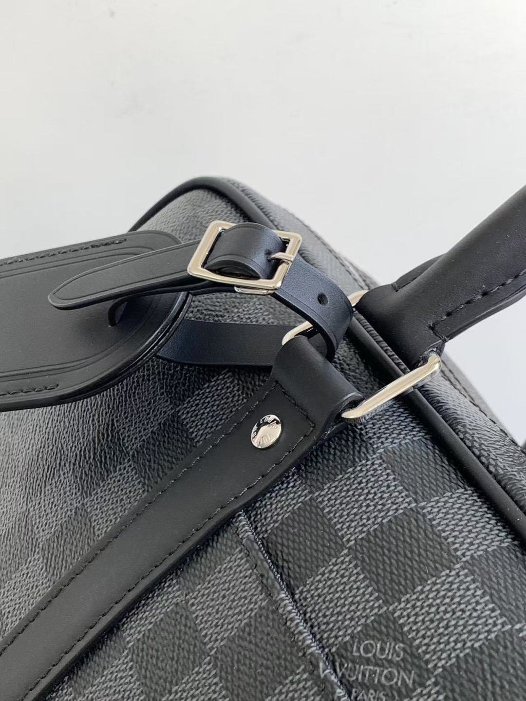 Louis Vuitton checkered bag strap with metal buckle and embossed logo, dark gray