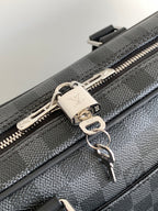 Louis Vuitton bag zipper pull with metal lock and chain, silver tone on dark gray