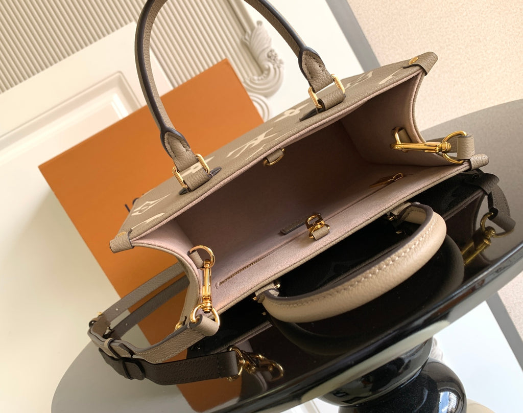 Louis Vuitton bag open top with gold zipper pull and interior lining, side angle view.
