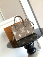 Louis Vuitton bag with monogram print and top handles, angled view.