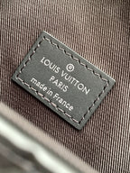 Louis Vuitton Paris made in France label on bag, stitched onto dark fabric