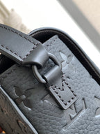 Louis Vuitton monogram bag detail with dark strap and silver-toned hardware