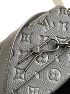 Louis Vuitton monogram satchel in gray textured material with metal clasp