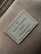 Louis Vuitton leather care label patch on dark textured bag lining