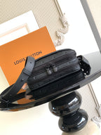 Louis Vuitton monogram crossbody bag showing front pockets, dark strap, and zipper details