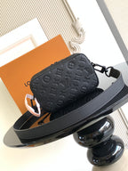 Louis Vuitton monogram crossbody bag with dark leather strap and front zipper closure