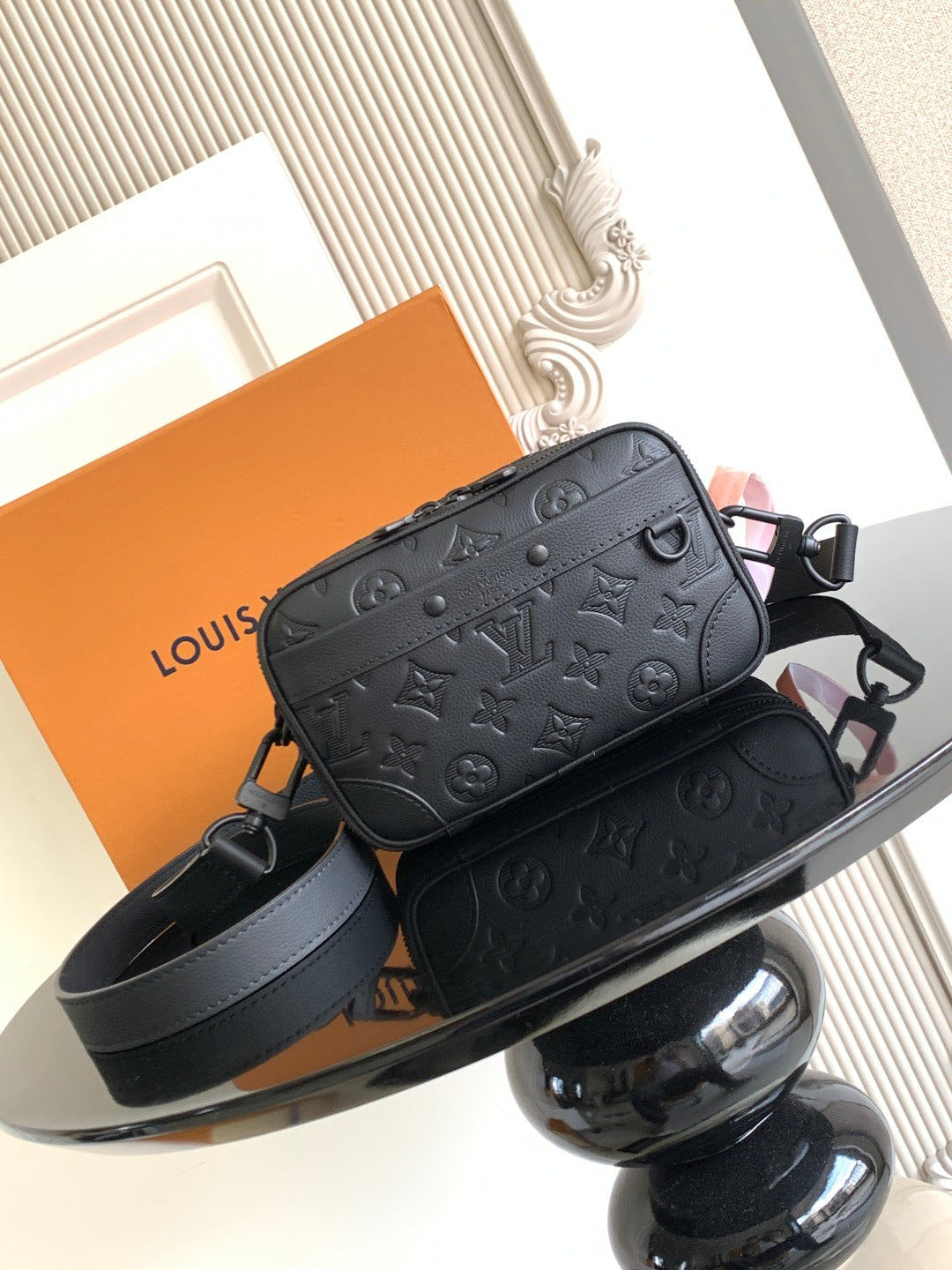 Louis Vuitton monogram crossbody bag in dark leather with adjustable strap and zipper