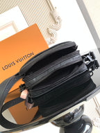 Louis Vuitton monogram crossbody bag side view with layered zippers and dark strap