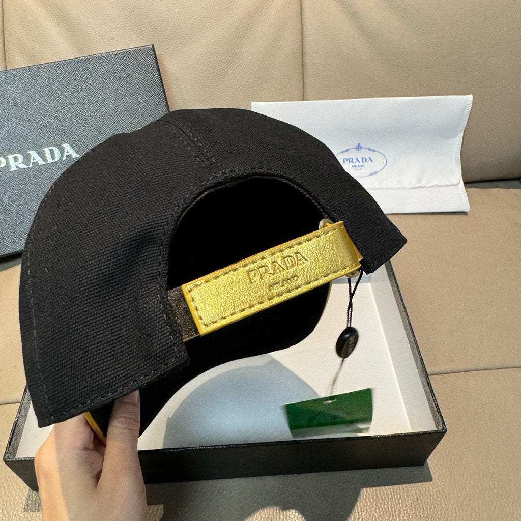 Black baseball cap with yellow interior strap and Prada logo patch near side.