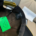 Black cap close-up of inner label and adjustable strap with Prada branding.