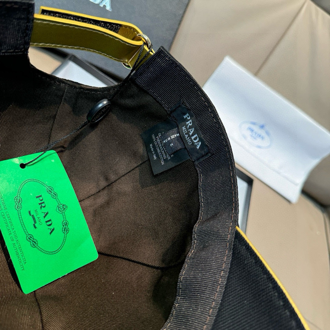 Black cap close-up of inner label and adjustable strap with Prada branding.