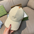 Gucci cap in beige GG monogram print with tan top button and curved brim