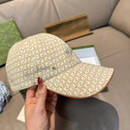 Gucci cap side view with beige GG monogram pattern and curved brown-edged brim