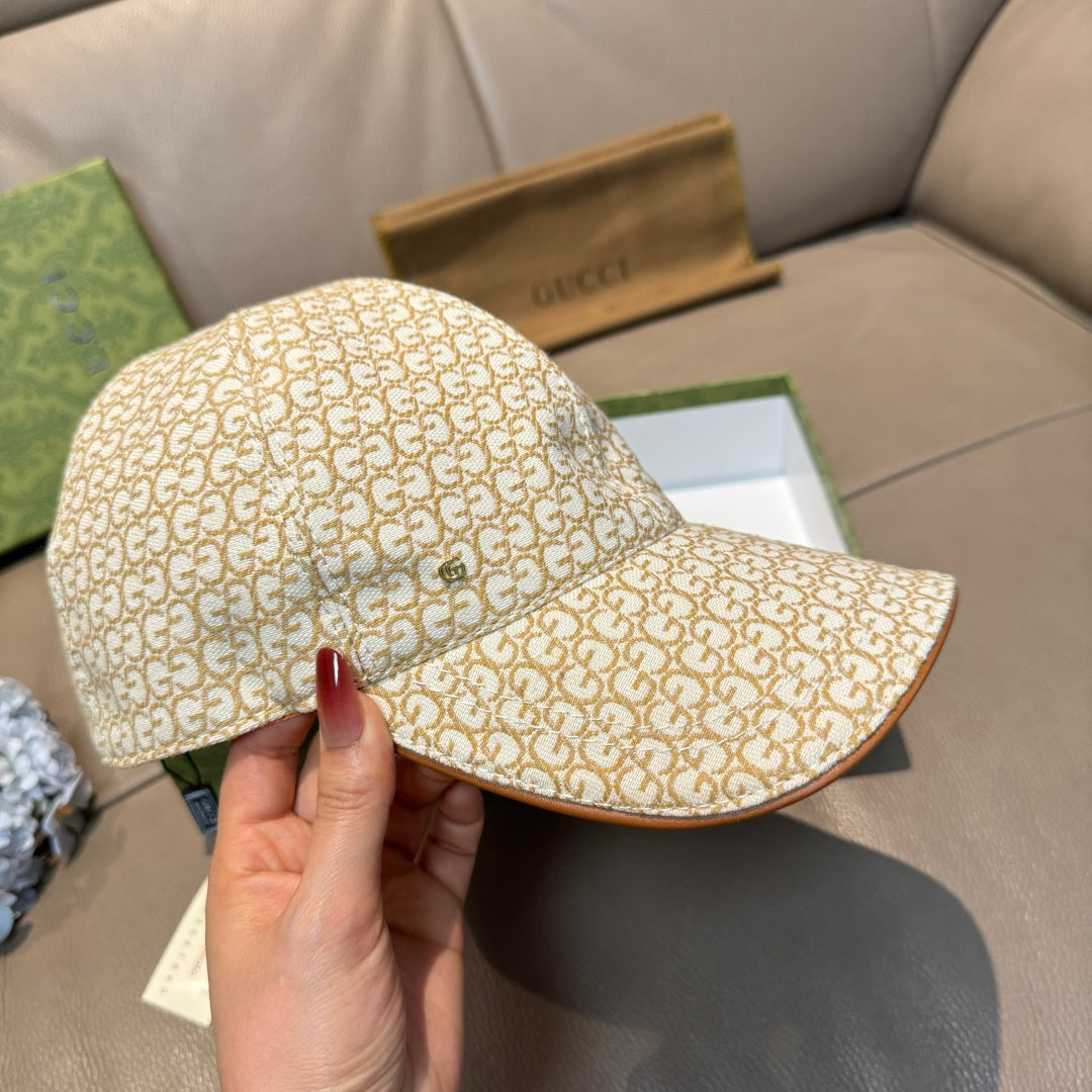Gucci cap side view with beige GG monogram pattern and curved brown-edged brim