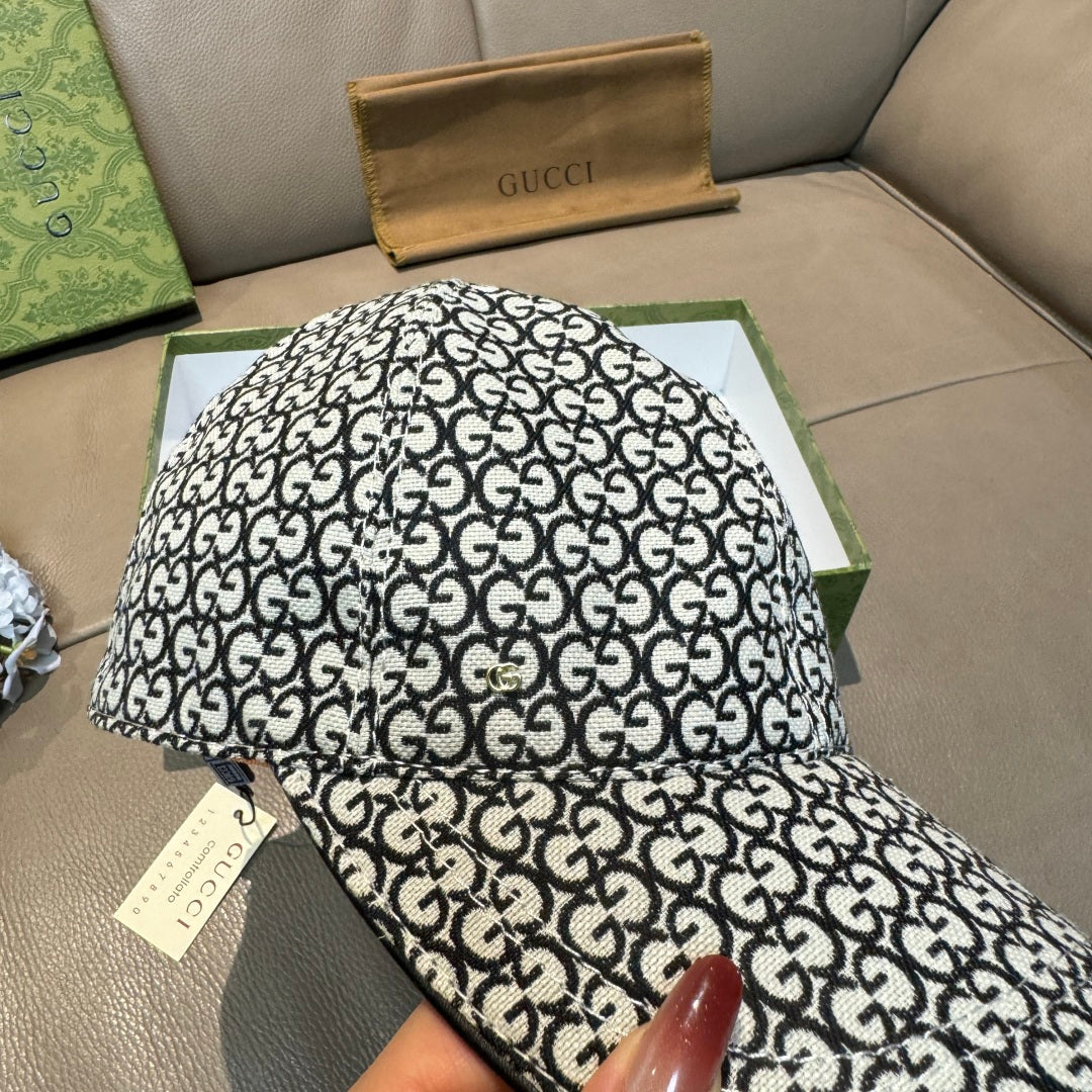 Gucci cap with black-and-white GG monogram allover pattern, close-up top view.