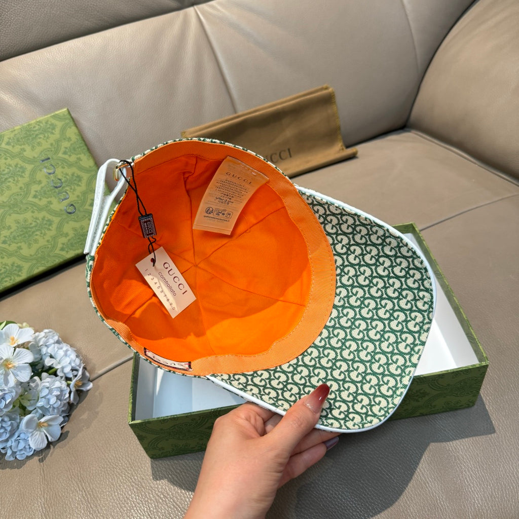 Gucci green GG monogram cap open view with orange interior lining