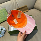 Gucci cap with pink GG monogram exterior and orange inner lining, tag attached