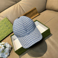 Gucci blue GG-pattern baseball cap with curved brim and black strap at back.