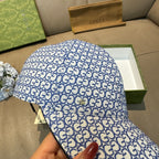 Gucci blue GG-pattern baseball cap, angled top view showing allover print.