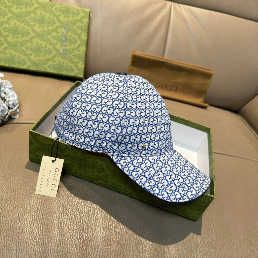 Gucci blue GG-pattern baseball cap, side view with curved brim and hanging tag.