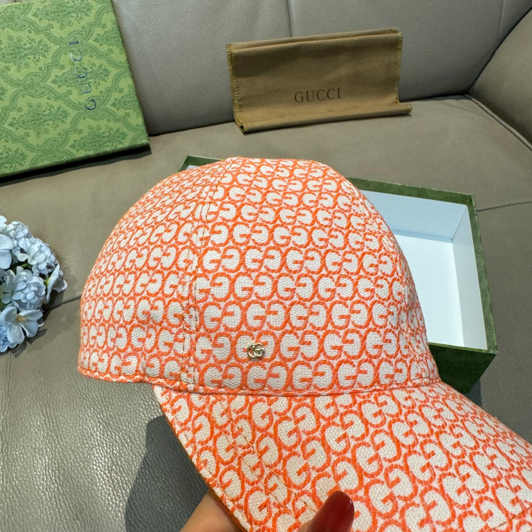 Orange GG-pattern baseball cap with curved brim, top and front close-up