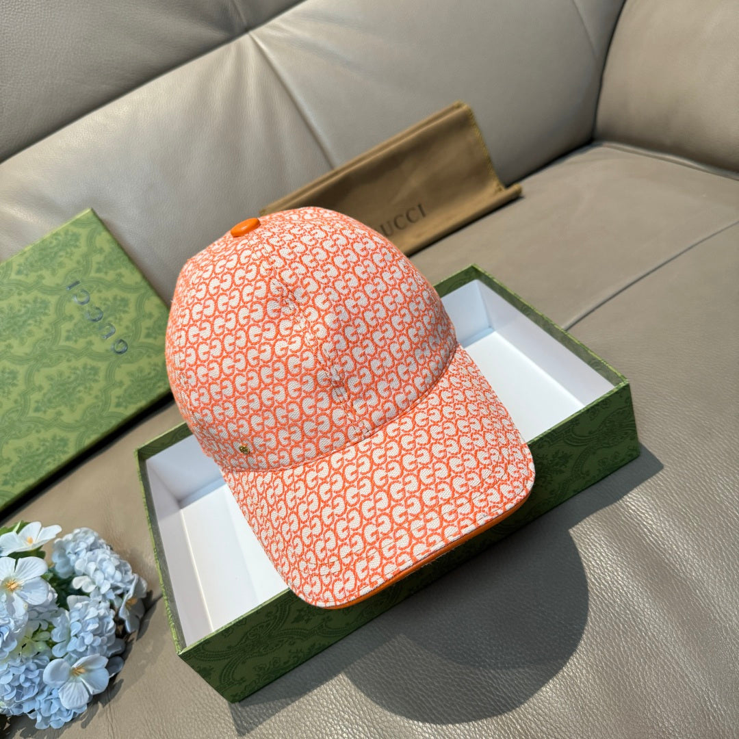 Orange GG-pattern baseball cap with curved brim and adjustable back strap