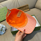 Orange GG-pattern baseball cap interior view with orange trim and strap