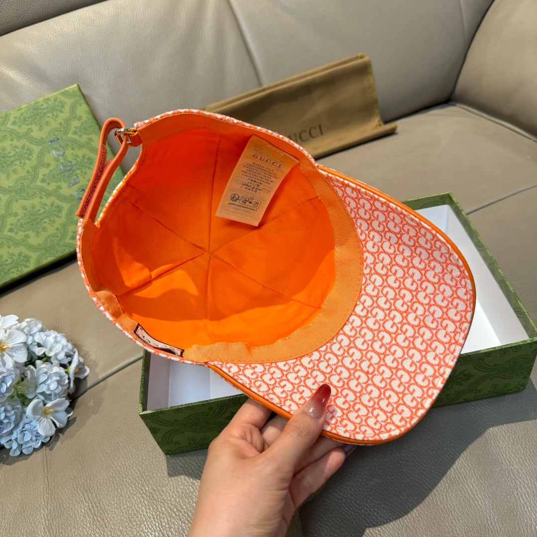Orange GG-pattern baseball cap interior view with orange trim and strap