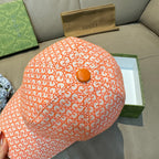 Orange GG-pattern baseball cap top view with small round button