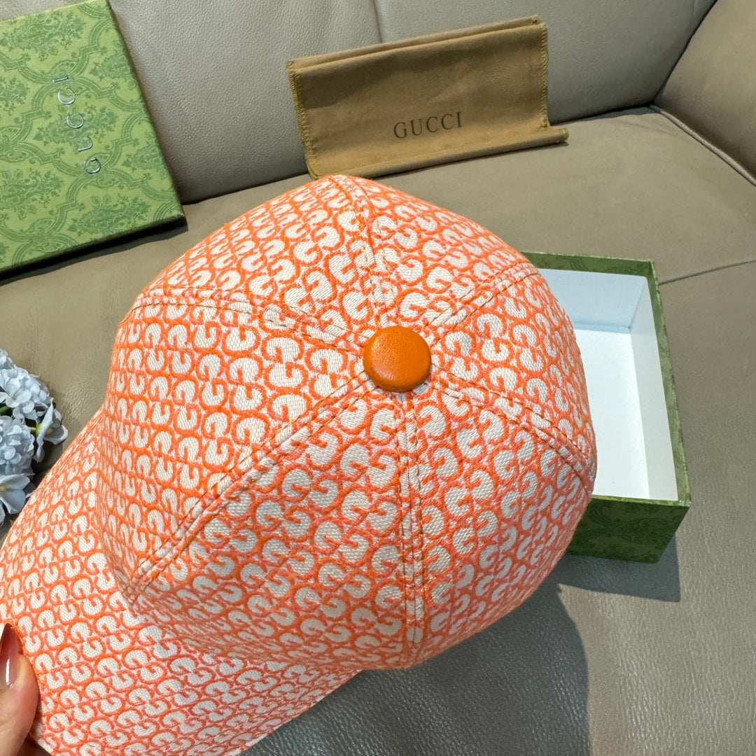 Orange GG-pattern baseball cap top view with small round button
