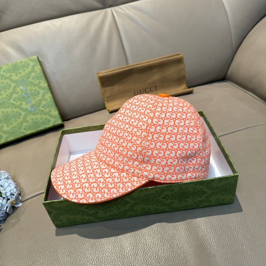 Orange GG-pattern baseball cap with curved brim, side view