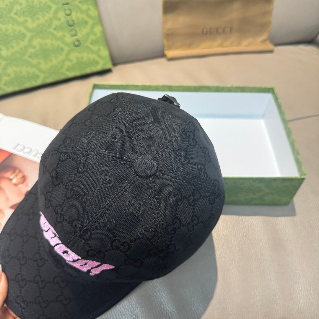 Black Gucci baseball cap with GG monogram texture and pink logo patch detail