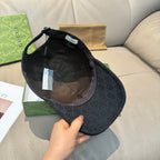 Black Gucci baseball cap interior with adjustable strap and size label visible