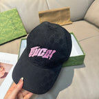 Black Gucci baseball cap with GG pattern and pink logo patch, three-quarter view
