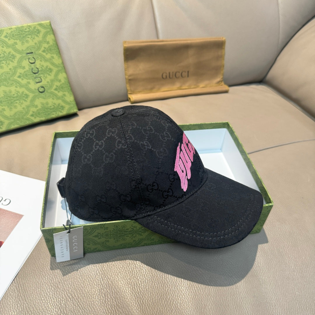 Black Gucci baseball cap with GG monogram texture and pink logo patch, side view