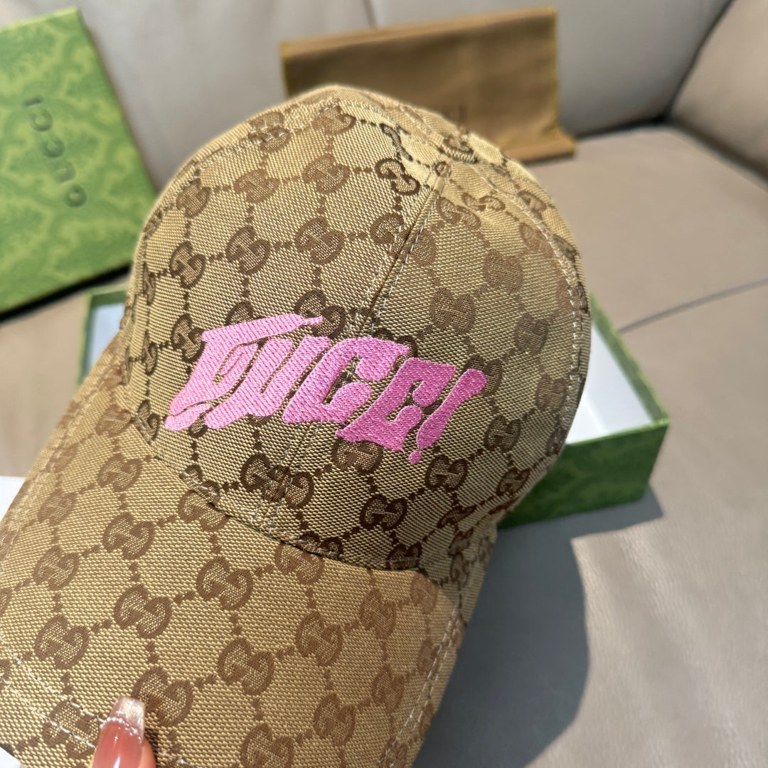 Gucci GG monogram cap close-up with pink logo on tan fabric