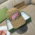 Gucci GG monogram cap with pink lettering on tan fabric