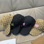 Gucci caps set with black and tan GG caps, each featuring pink logo patches