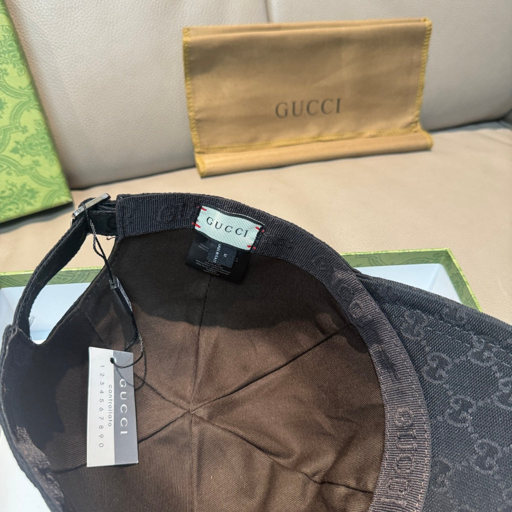 Black Gucci cap interior view with adjustable strap and GG canvas lining.