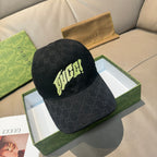 Black Gucci baseball cap with GG monogram and neon logo patch at front.