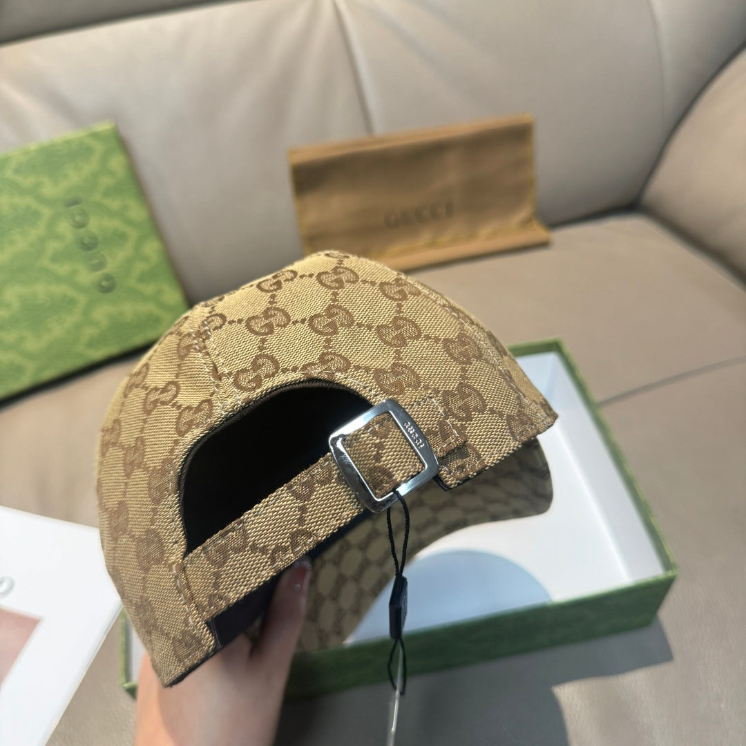 Gucci cap with tan GG exterior, black interior, and metal buckle strap