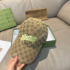 Gucci cap in tan GG monogram canvas with neon green front logo, angled view