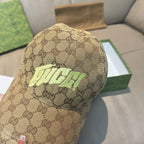Gucci cap in tan GG monogram canvas with neon green front logo, close-up